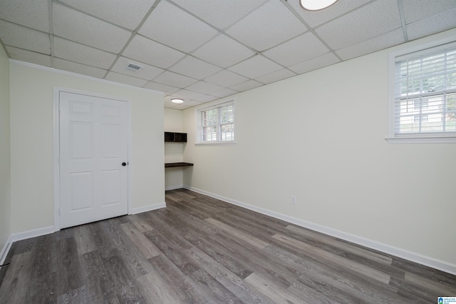 basement featuring hardwood / wood-style flooring and a drop ceiling