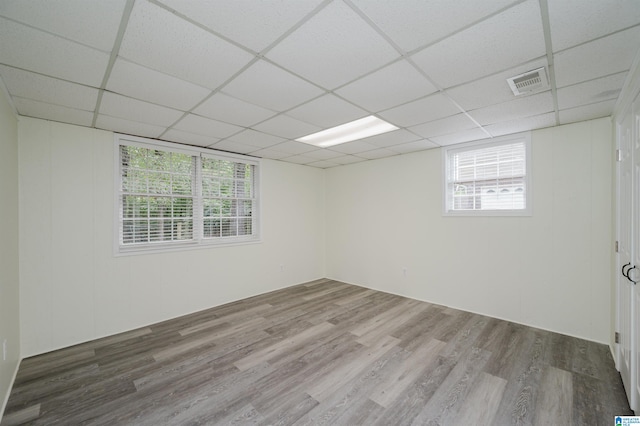 unfurnished room featuring a drop ceiling and wood-type flooring