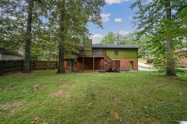 rear view of property with a wooden deck and a yard