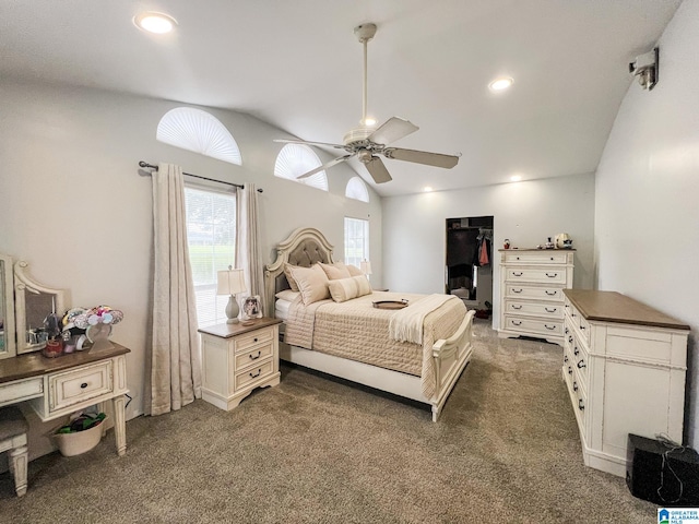 bedroom featuring vaulted ceiling, dark colored carpet, and ceiling fan