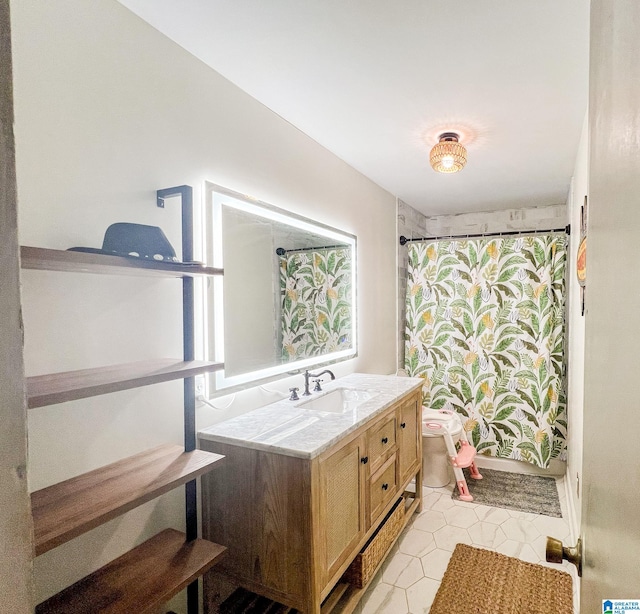 bathroom featuring a shower with shower curtain, tile patterned floors, and vanity