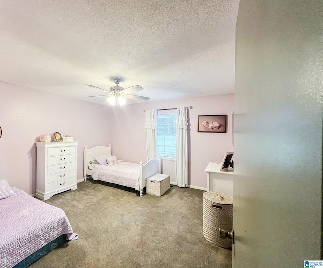 bedroom featuring a textured ceiling, light carpet, and ceiling fan