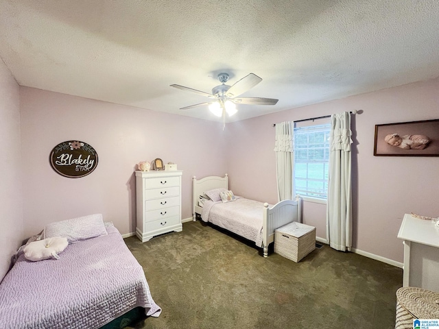 bedroom with ceiling fan, a textured ceiling, and dark colored carpet