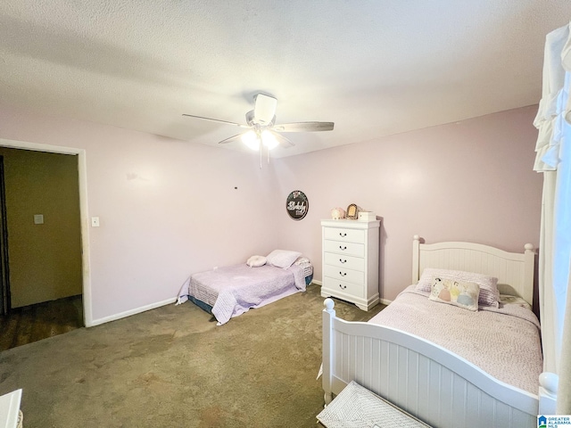 bedroom featuring ceiling fan, a textured ceiling, and dark colored carpet