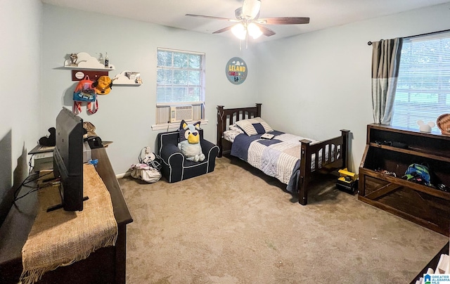 carpeted bedroom featuring multiple windows, cooling unit, and ceiling fan