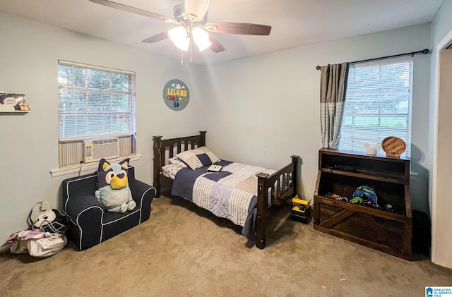 carpeted bedroom featuring ceiling fan and cooling unit