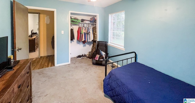 bedroom with a closet and light colored carpet