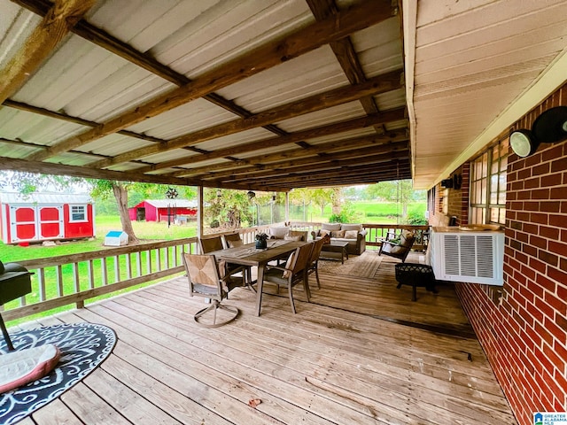 wooden terrace featuring a storage shed and a lawn