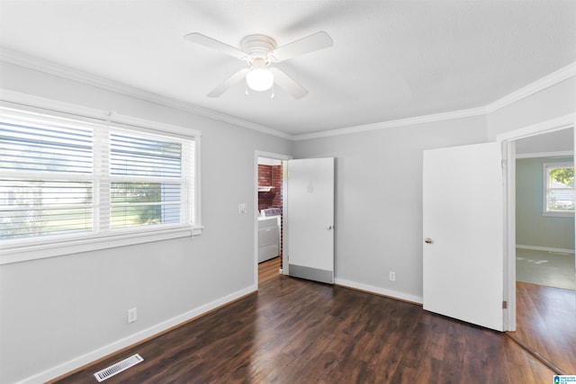 unfurnished bedroom featuring washer / dryer, ceiling fan, crown molding, and dark hardwood / wood-style flooring