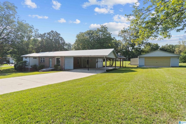 single story home featuring a garage, a front yard, and an outbuilding