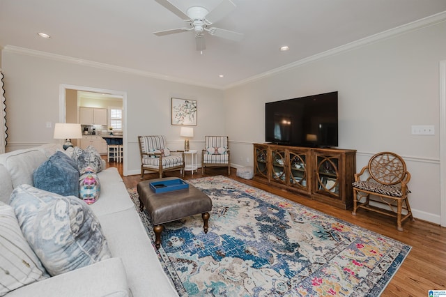 living room featuring ceiling fan, crown molding, and hardwood / wood-style floors