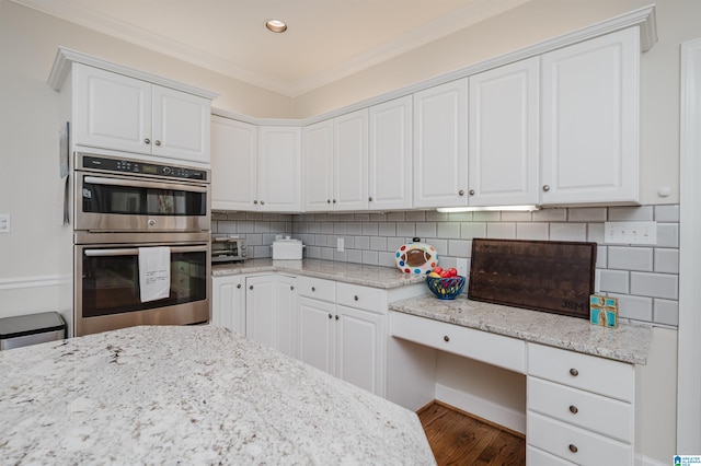 kitchen with crown molding, double oven, dark hardwood / wood-style floors, and white cabinetry