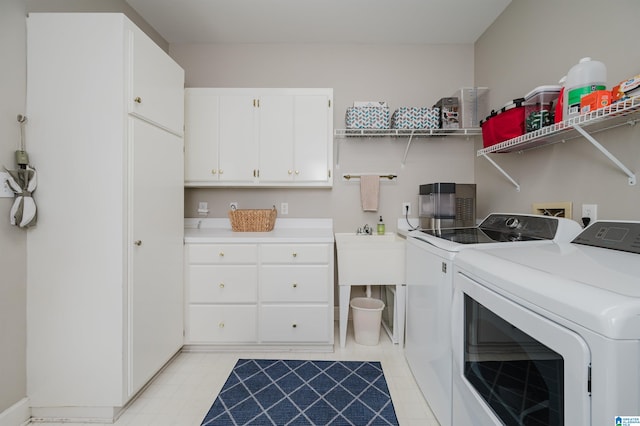 laundry room featuring cabinets and washing machine and dryer