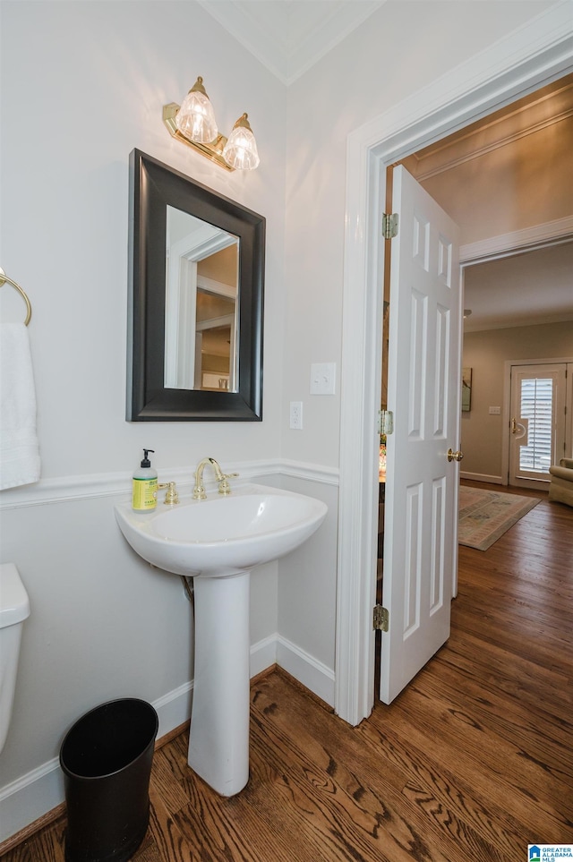 bathroom with toilet and hardwood / wood-style floors