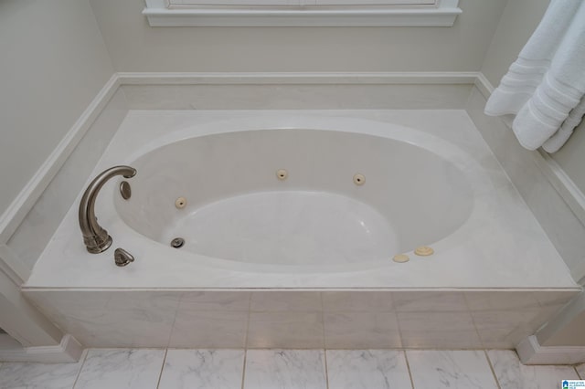 bathroom featuring tiled tub