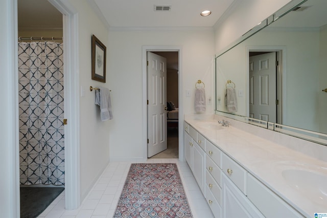 bathroom featuring tile patterned flooring, vanity, and crown molding