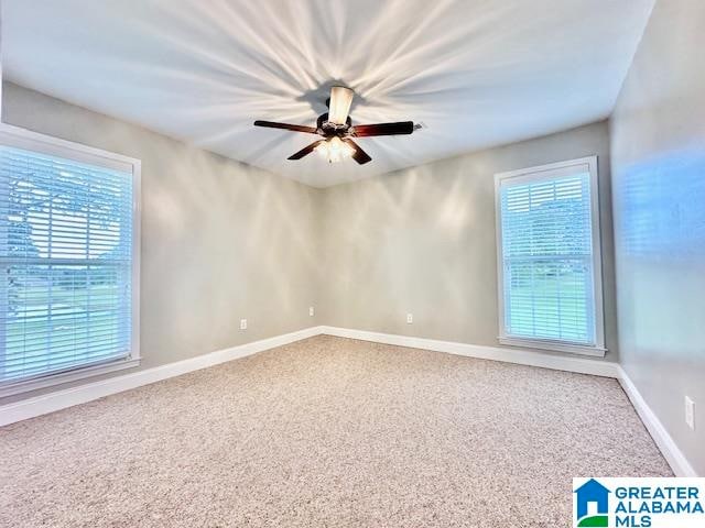 carpeted empty room featuring ceiling fan