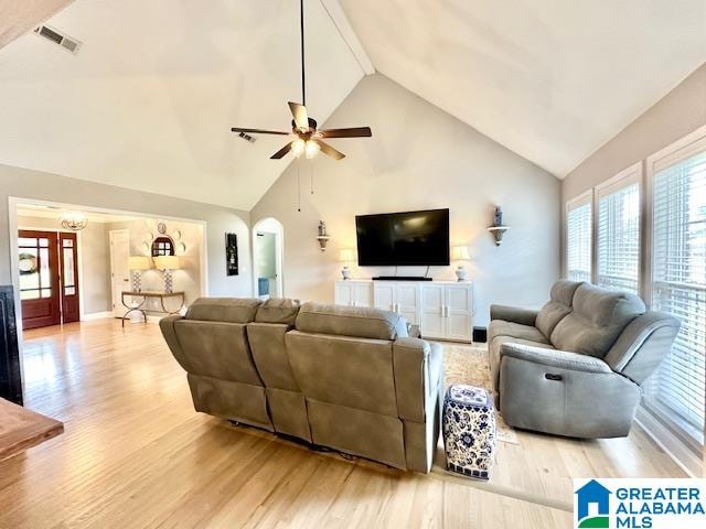 living room featuring high vaulted ceiling, light hardwood / wood-style floors, and ceiling fan