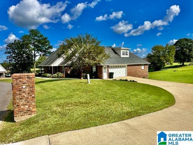 view of front of home featuring a garage and a front lawn