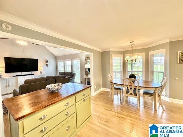 kitchen with a wealth of natural light, wood counters, light wood-type flooring, and crown molding