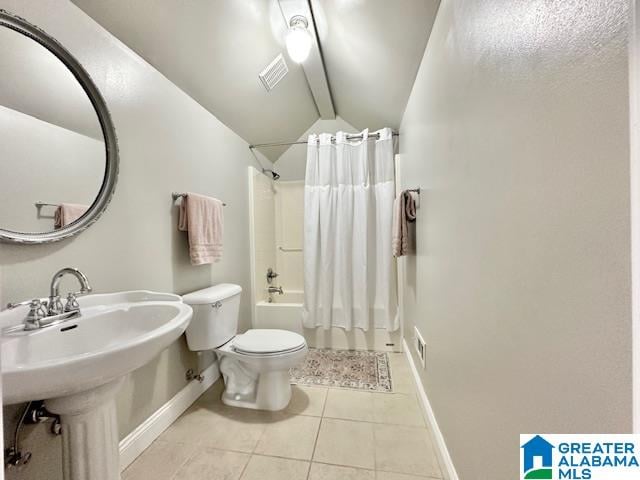 bathroom with shower / bathtub combination with curtain, vaulted ceiling, tile patterned flooring, and toilet