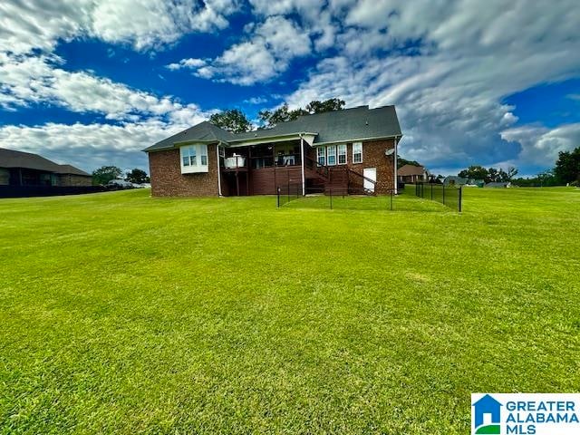 back of property featuring a lawn