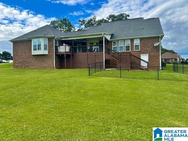 rear view of property with a yard