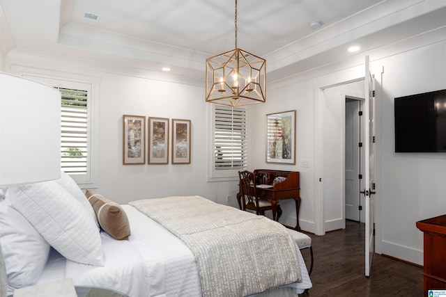 bedroom featuring dark hardwood / wood-style floors and a chandelier