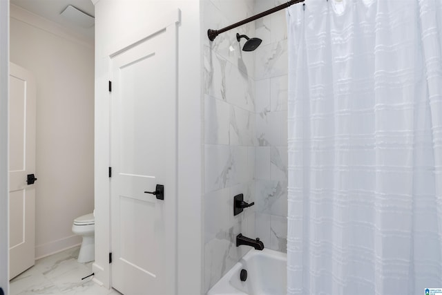 bathroom featuring shower / tub combo and toilet