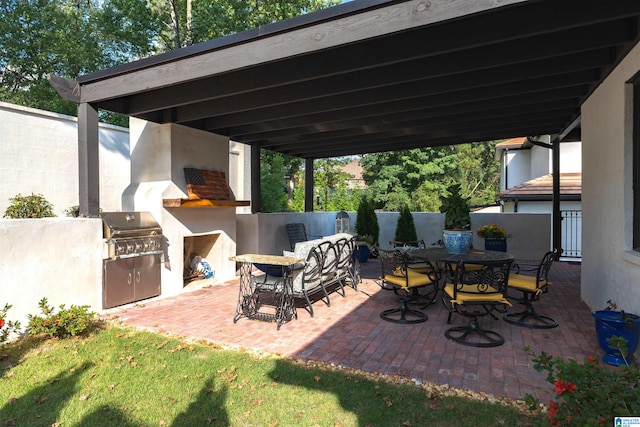 view of patio / terrace with area for grilling and a fireplace