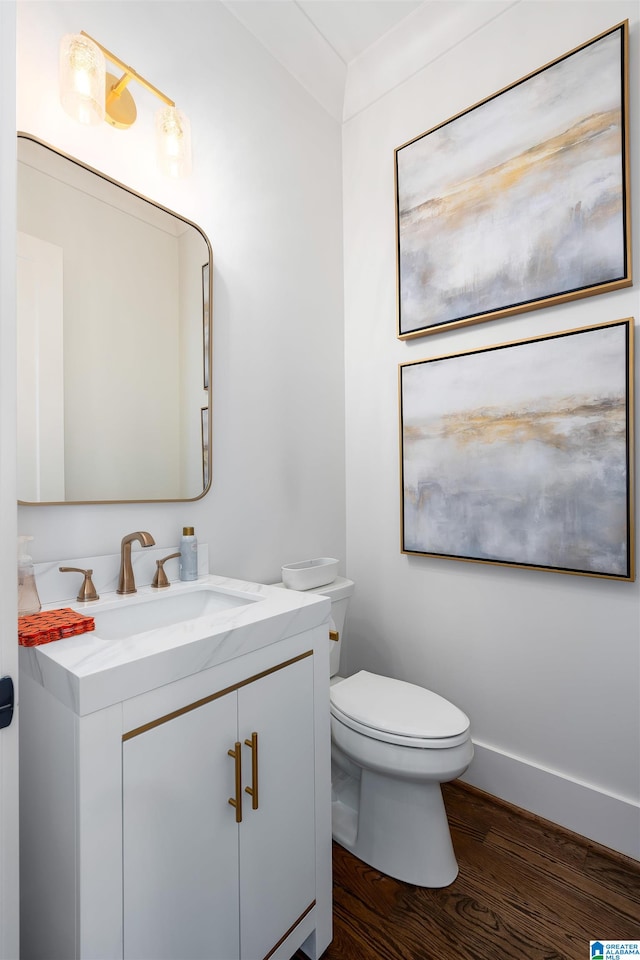 bathroom featuring hardwood / wood-style floors, vanity, and toilet