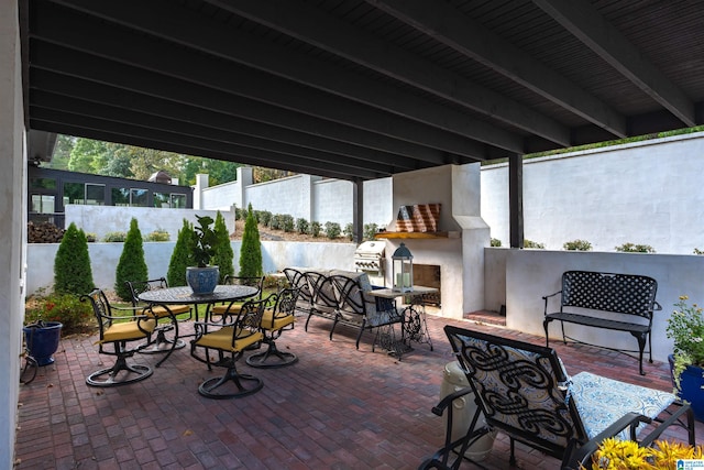 view of patio with exterior fireplace