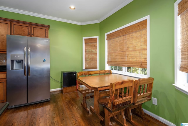 dining room with dark hardwood / wood-style floors and ornamental molding