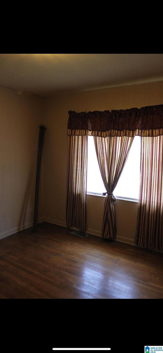 unfurnished room featuring dark hardwood / wood-style floors