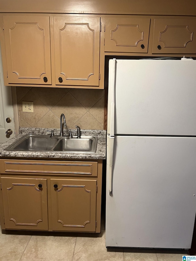 kitchen with sink, white fridge, and backsplash