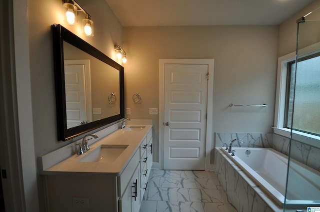 bathroom with tiled bath and vanity