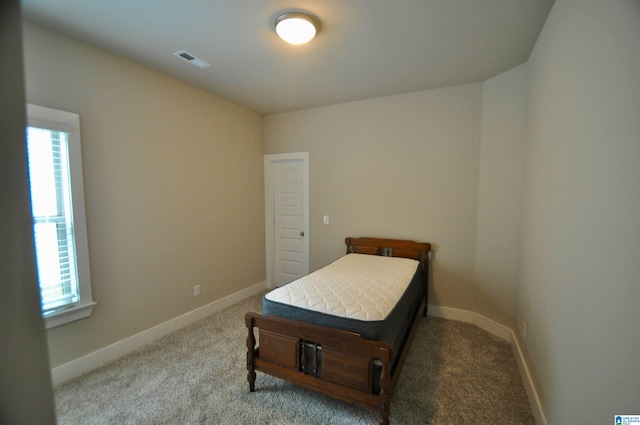 bedroom featuring light carpet