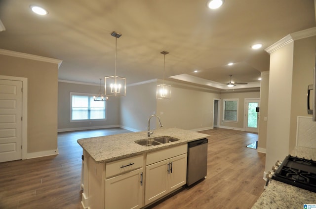 kitchen with pendant lighting, sink, ceiling fan with notable chandelier, stainless steel appliances, and crown molding