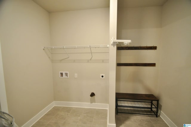 washroom featuring washer hookup, electric dryer hookup, and light tile patterned floors