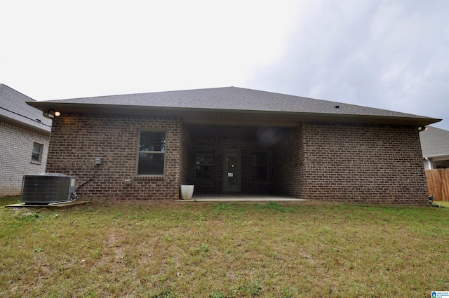 back of house featuring a lawn, central air condition unit, and a patio area