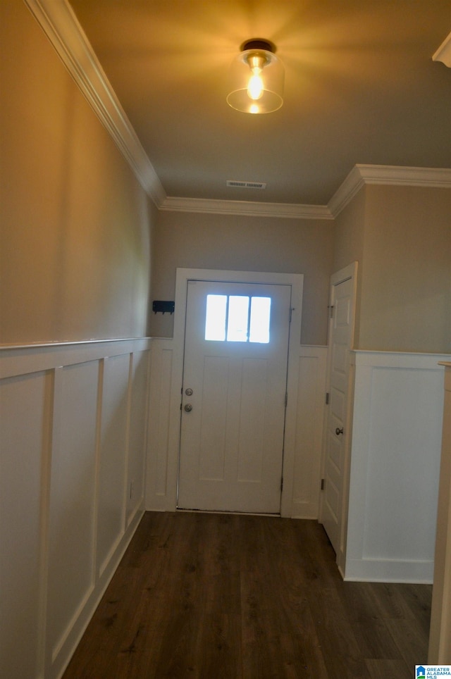 entryway with ornamental molding and dark wood-type flooring