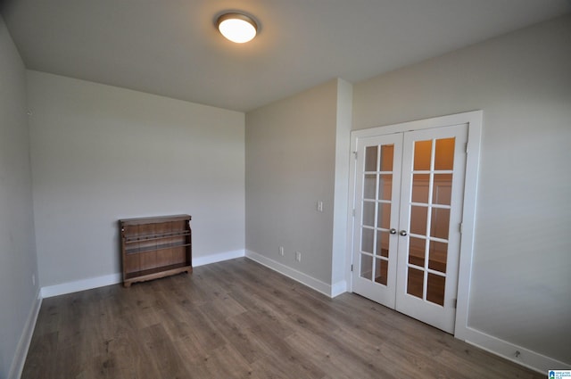 unfurnished room featuring french doors and hardwood / wood-style flooring