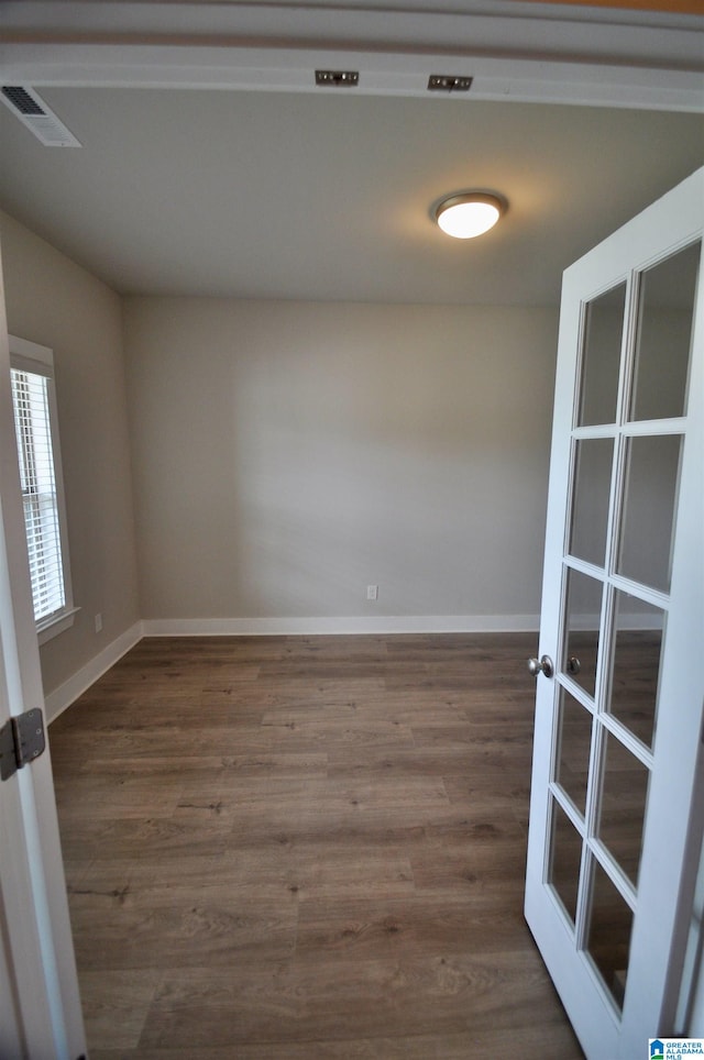 unfurnished room featuring dark hardwood / wood-style floors