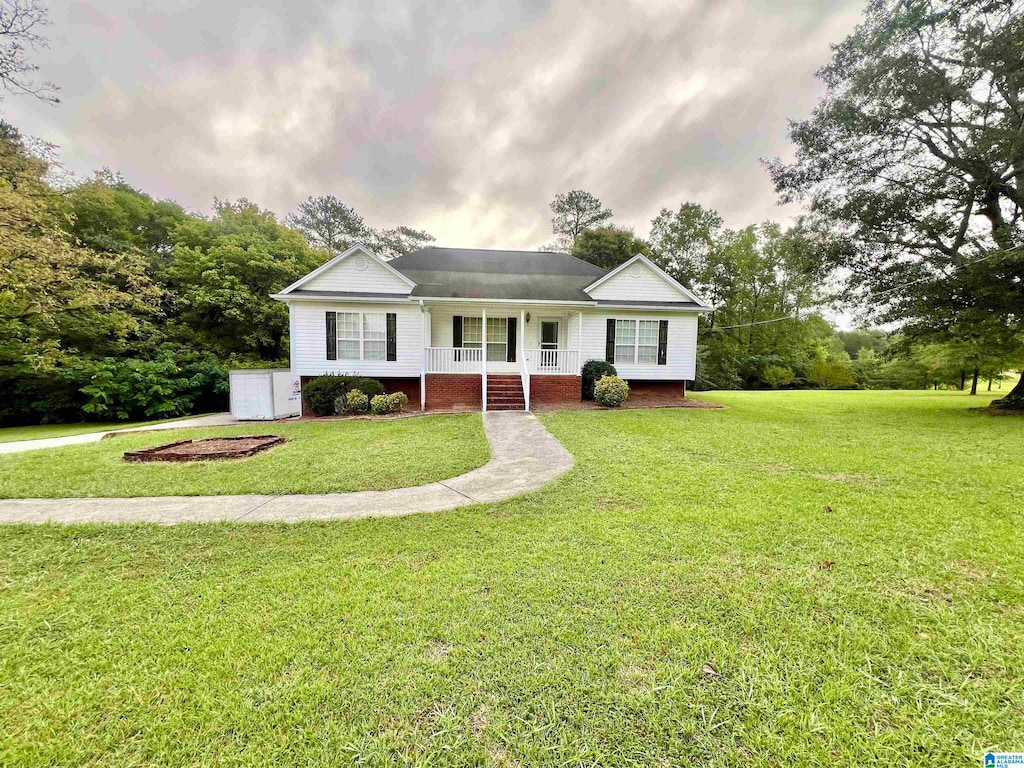 view of front of house with a front yard and a porch