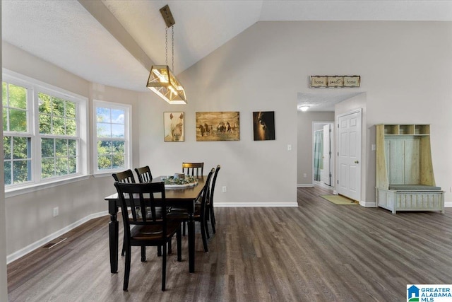 dining space featuring dark hardwood / wood-style floors and vaulted ceiling