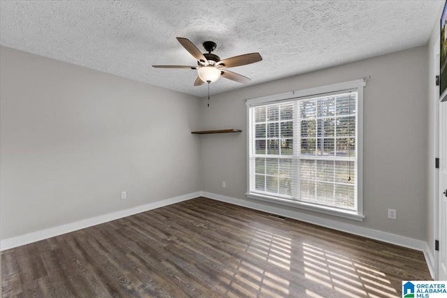 empty room featuring a textured ceiling, ceiling fan, and dark wood-type flooring