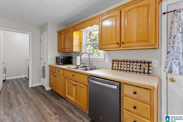 kitchen with dark hardwood / wood-style flooring, sink, stainless steel appliances, and a textured ceiling