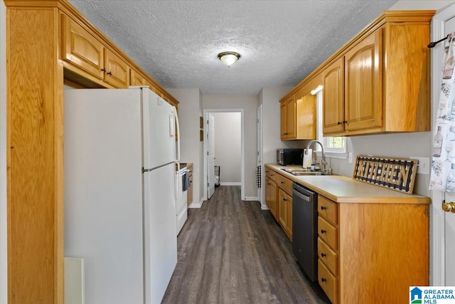 kitchen featuring a textured ceiling, sink, dark hardwood / wood-style floors, and white appliances