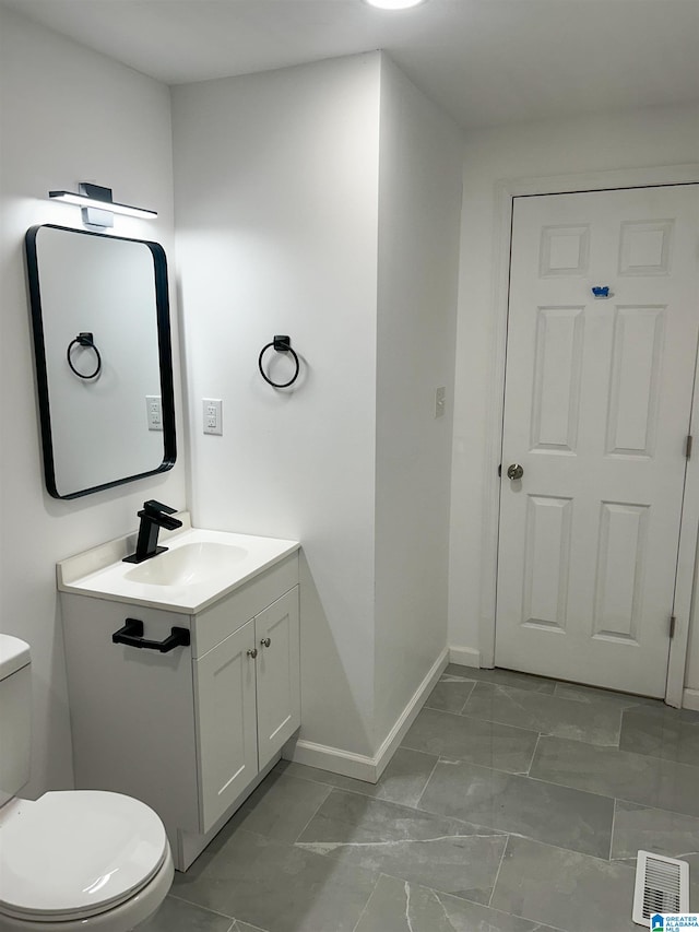 bathroom with vanity and toilet