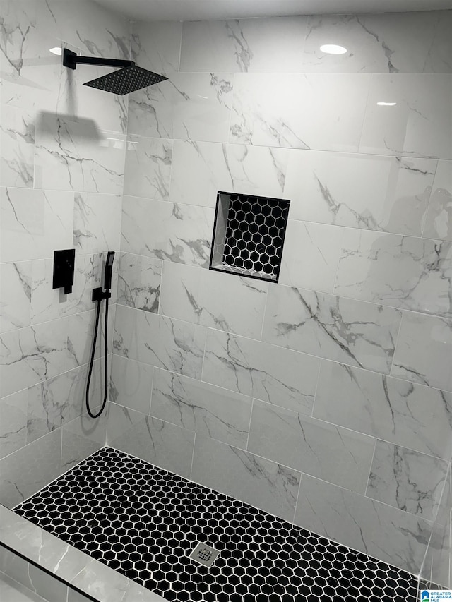 bathroom with a tile shower